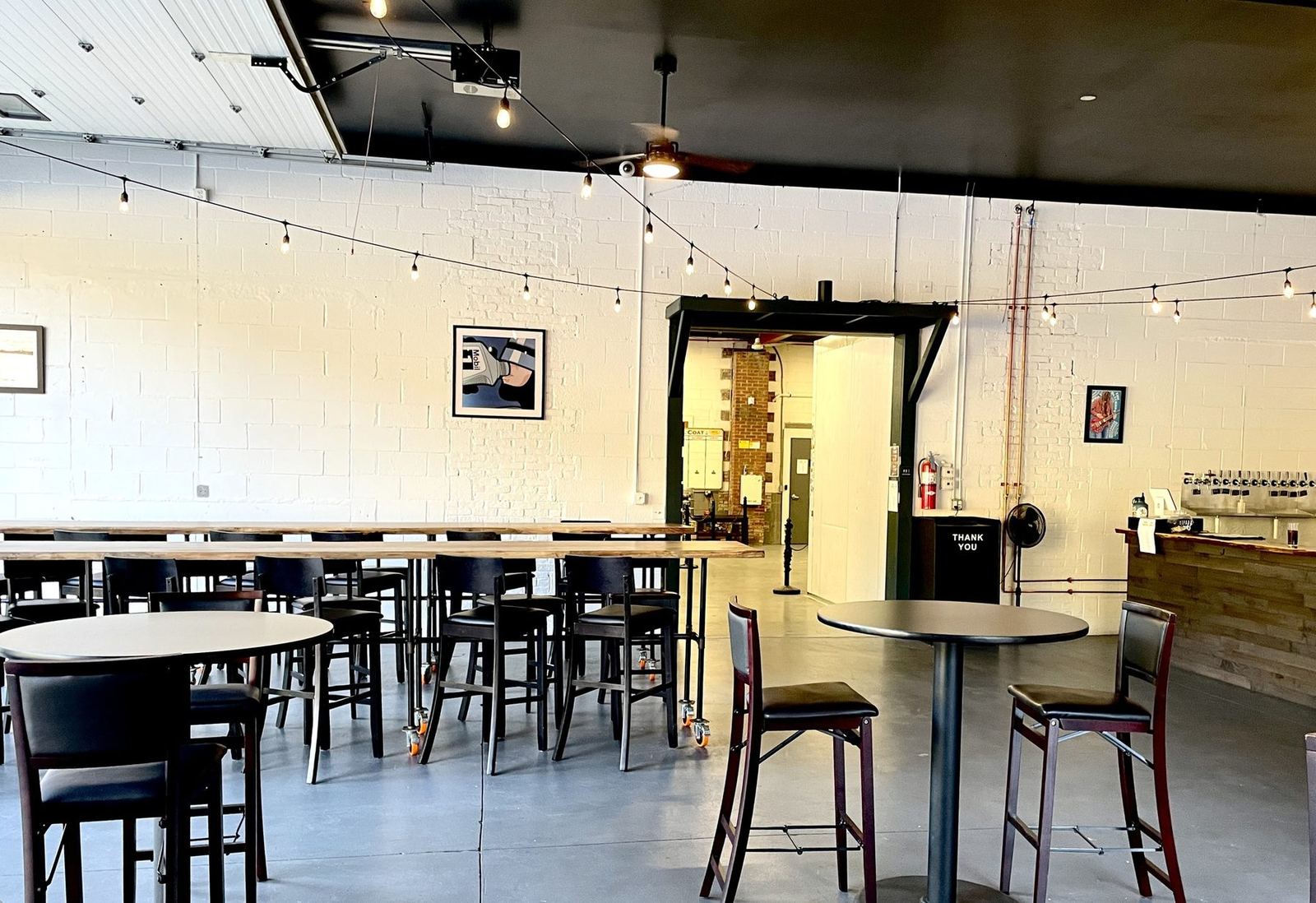 Communal tables in the Vernon Brewing taproom, daylight